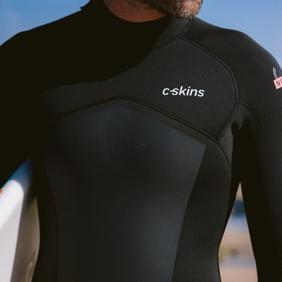 Close up of man wearing C-Skins Men's NuWave Legend 5mm 4mm 3mm Back Zip GBS Steamer Black Neon Flare C-NLE54MBZ