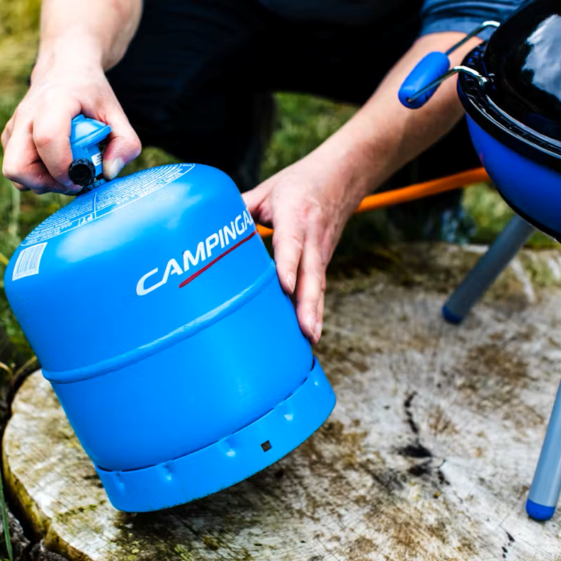 Man connecting a Camping Gaz 907 Gas Refill Only GAS907 to a camping stove