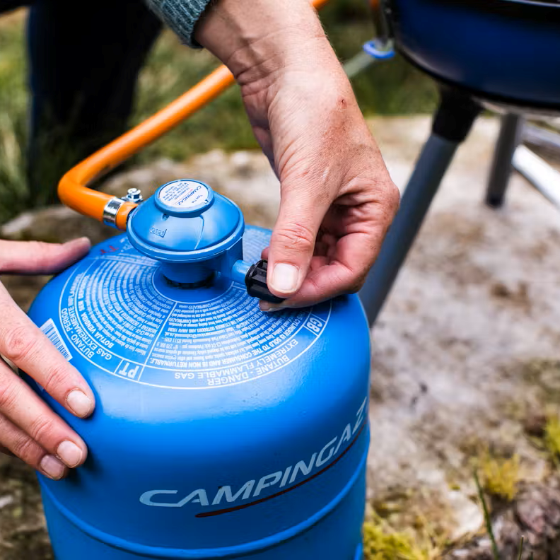 Camping Gaz 907 Cylinder Bottle Gas GAS907CYL being connected to a camping stove in the forest
