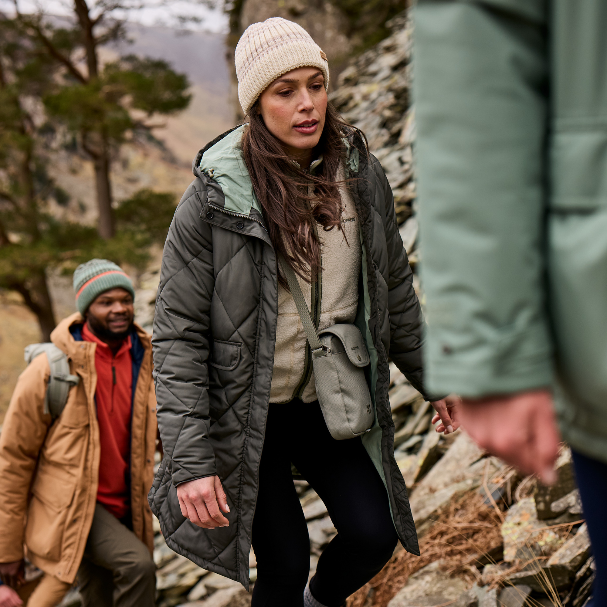 Woman wearing Craghoppers Women’s Sweetgrass National Trust Insulated Parka Nori Green 1KZ CWN309 while walking on a trail