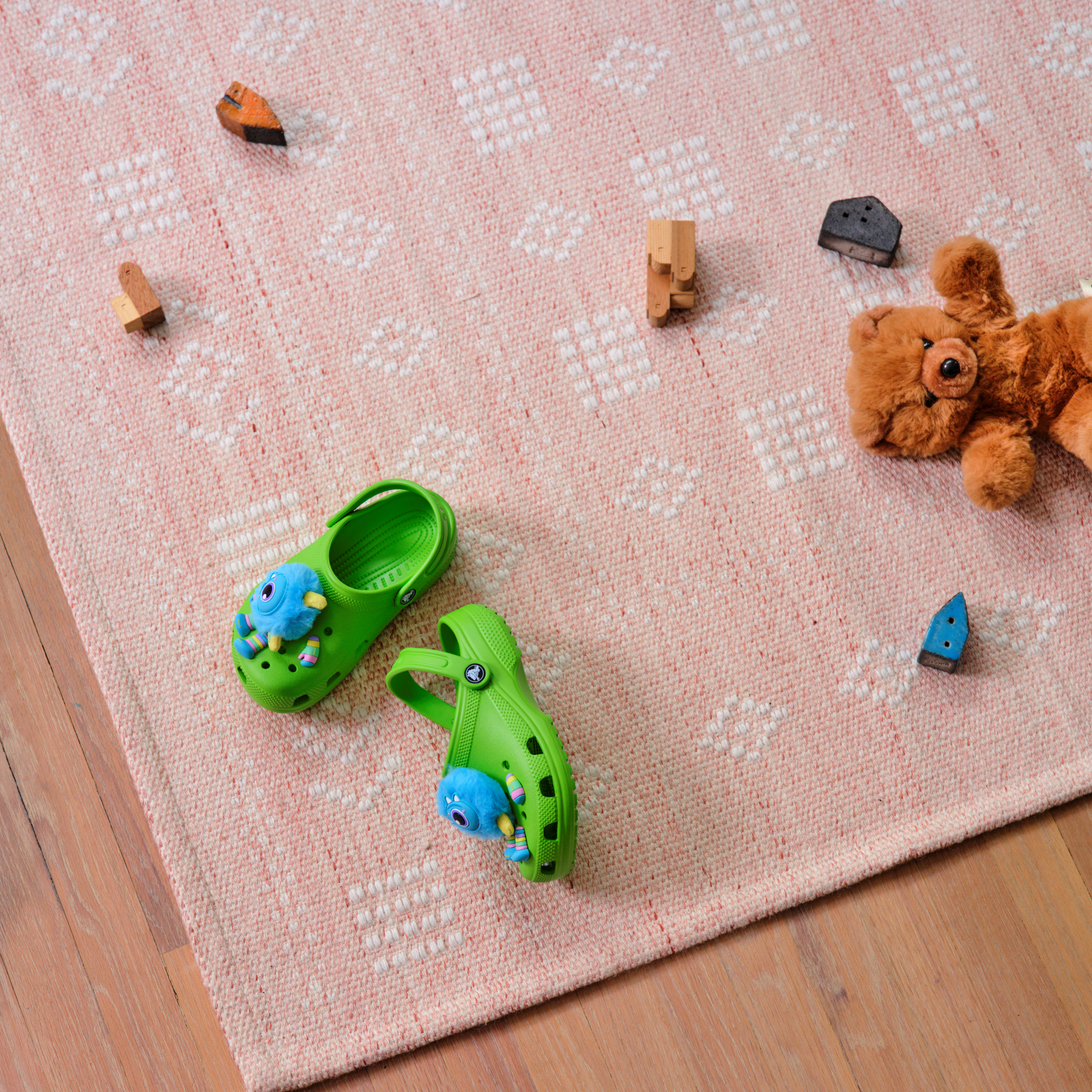 Crocs Classic Clogs Junior Crocs Green 30T 206991 sitting on the floor of a playroom