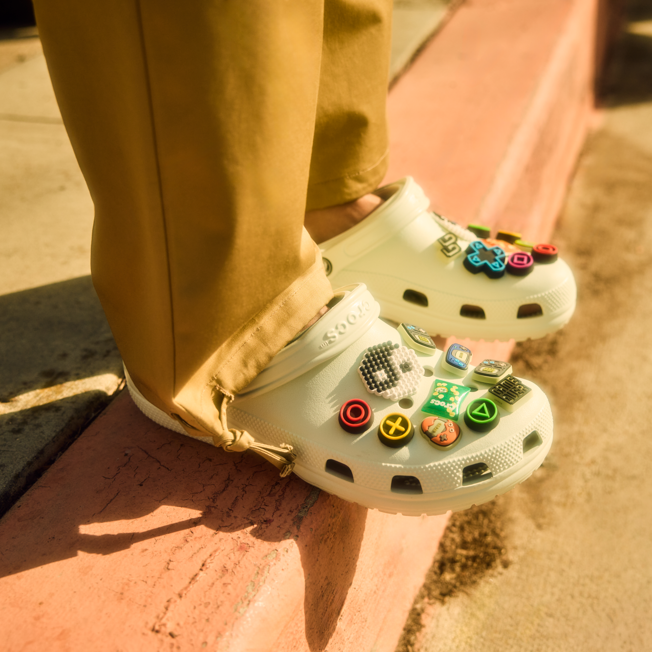 Person wearing Crocs Unisex Classic Clogs Mint Tint 3YF 10001 standing on a curb