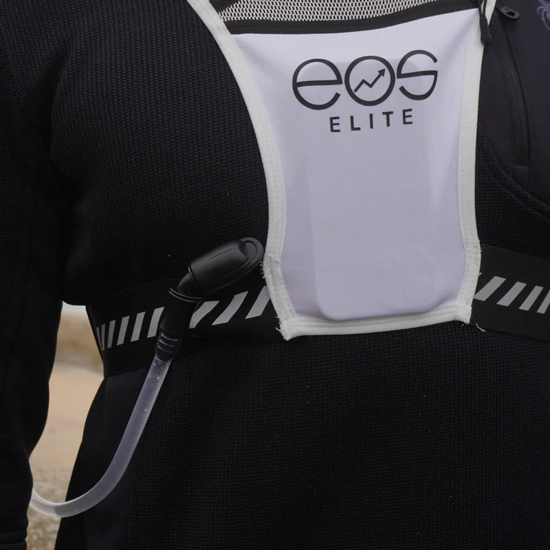 Person wearing an EOS Elite hydration vest with a black jacket.