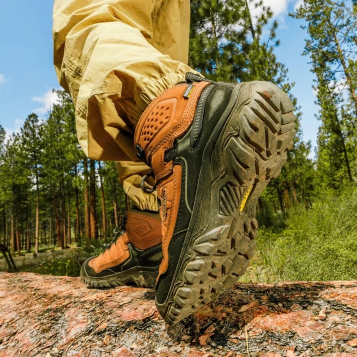 Person hiking in Keen Men's Targhee IV Waterproof Mid Trail Boots Wide Fit Bison Black 1029002