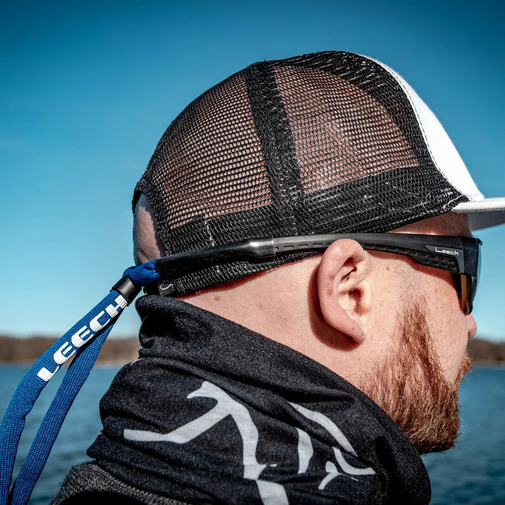 Man wearing Leech Neoprene Floating Eyewear Strap Blue PL-FS2106 on a boat
