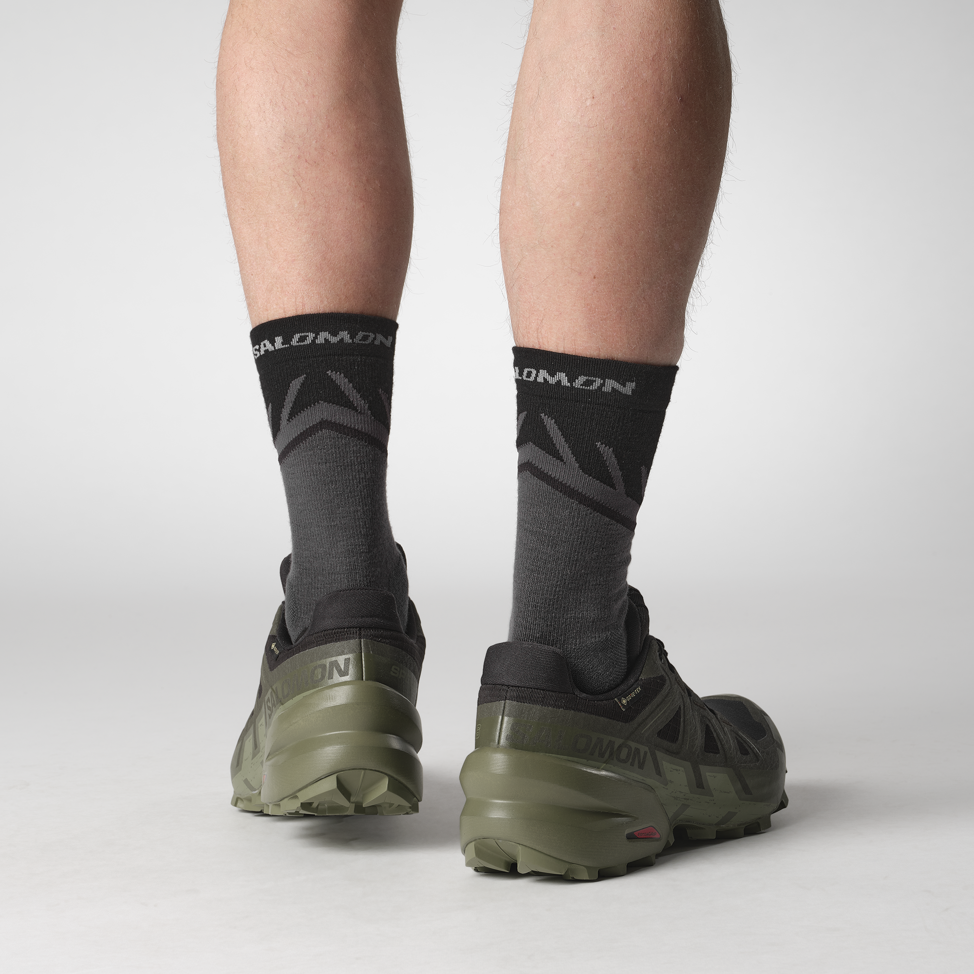 Rear view of Man wearing Salomon Men's Speedcross 6 Gore-Tex Trail Running Shoes Black Peat Deep Lichen Green L47584100