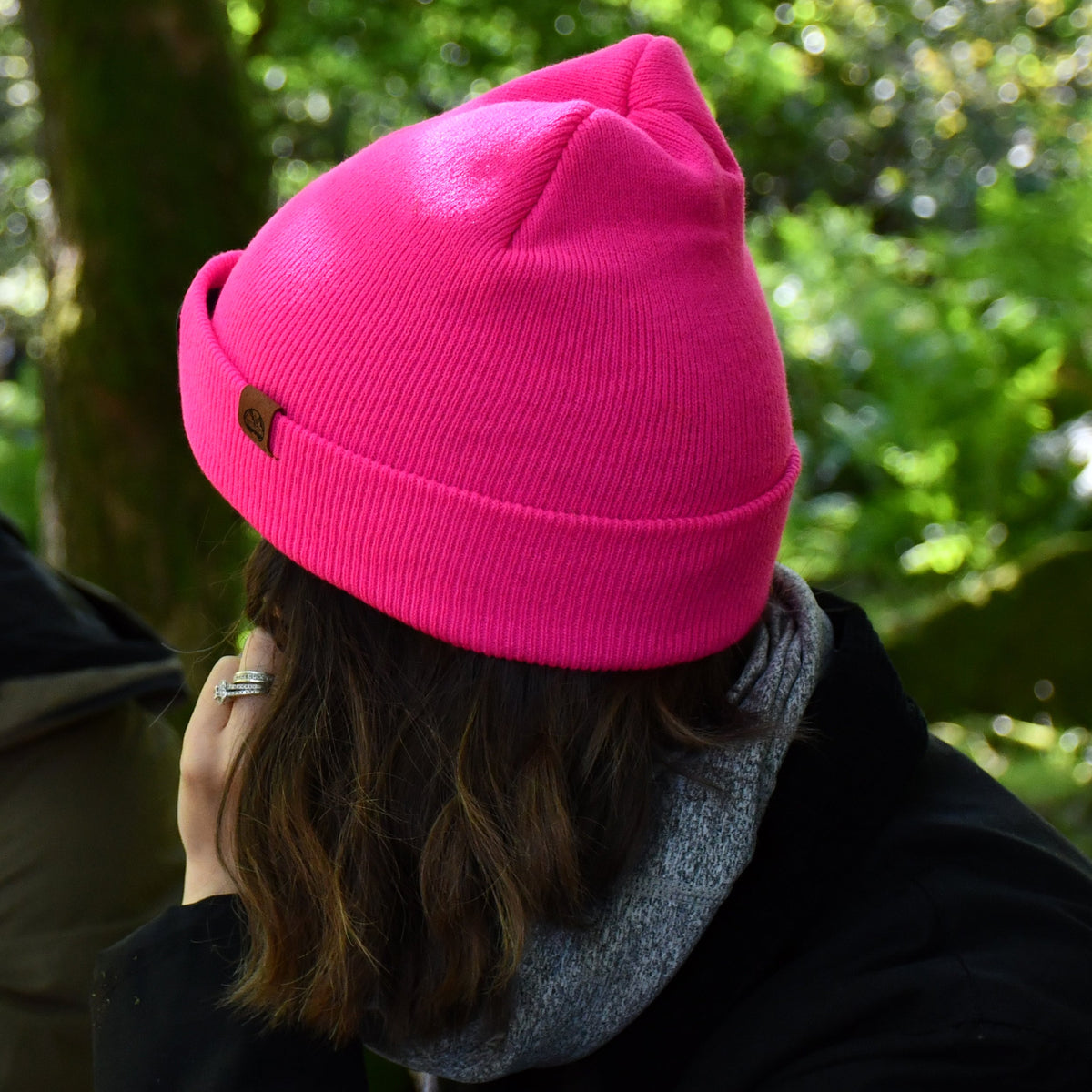 Person wearing a Six Peaks Unisex LED Lighted Beanie Hat Pink SIH0004 in a forest setting