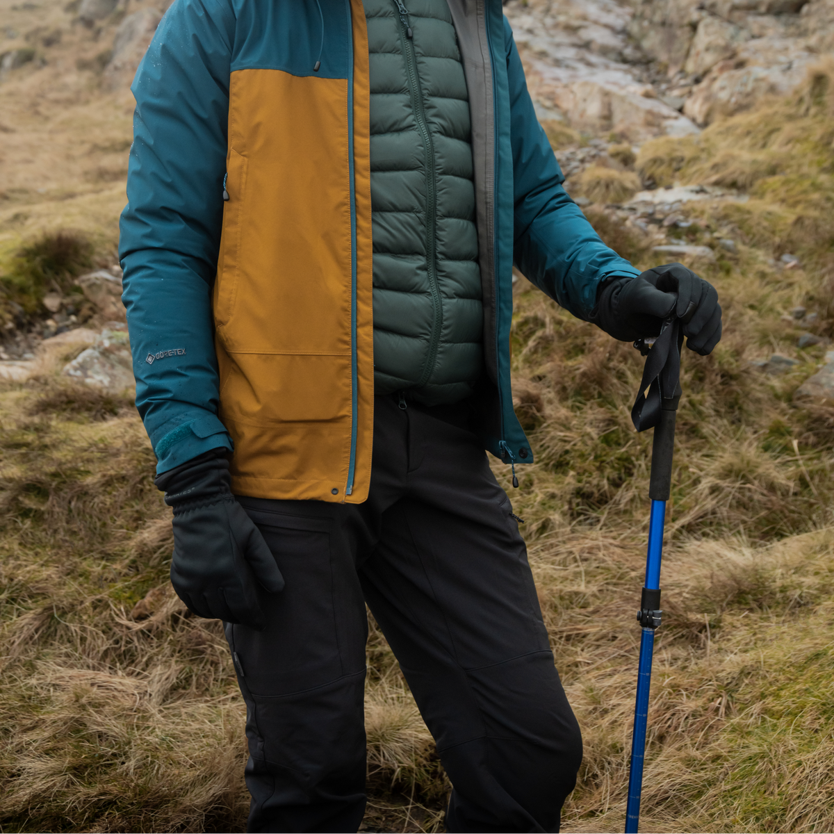 Man in outdoor gear with a Trekmates Trekker Compact Single Pole Cobalt TM-008702 on a mountain trail