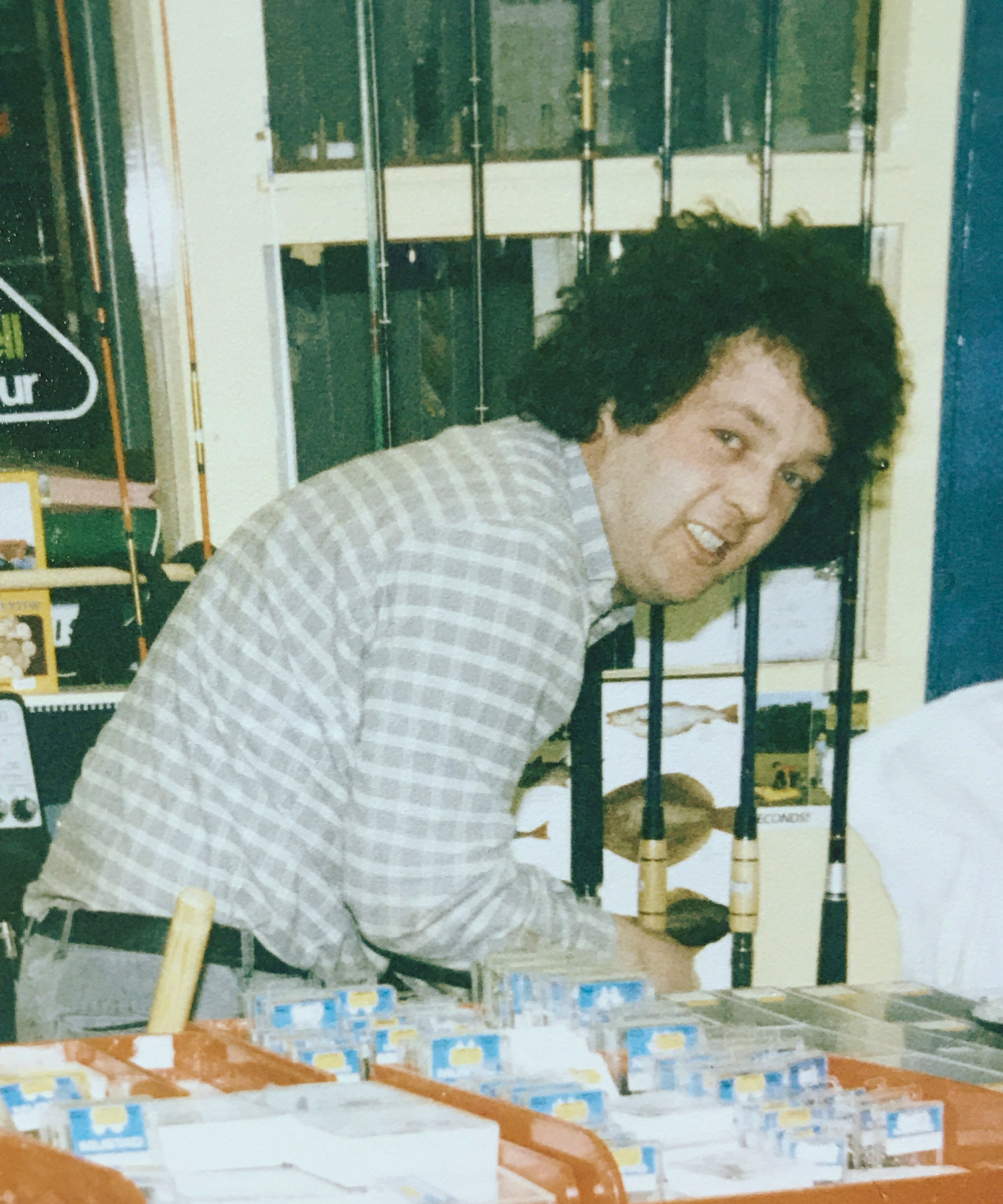 Tim Landers standing behind the original Landers Tralee shop fishing counter