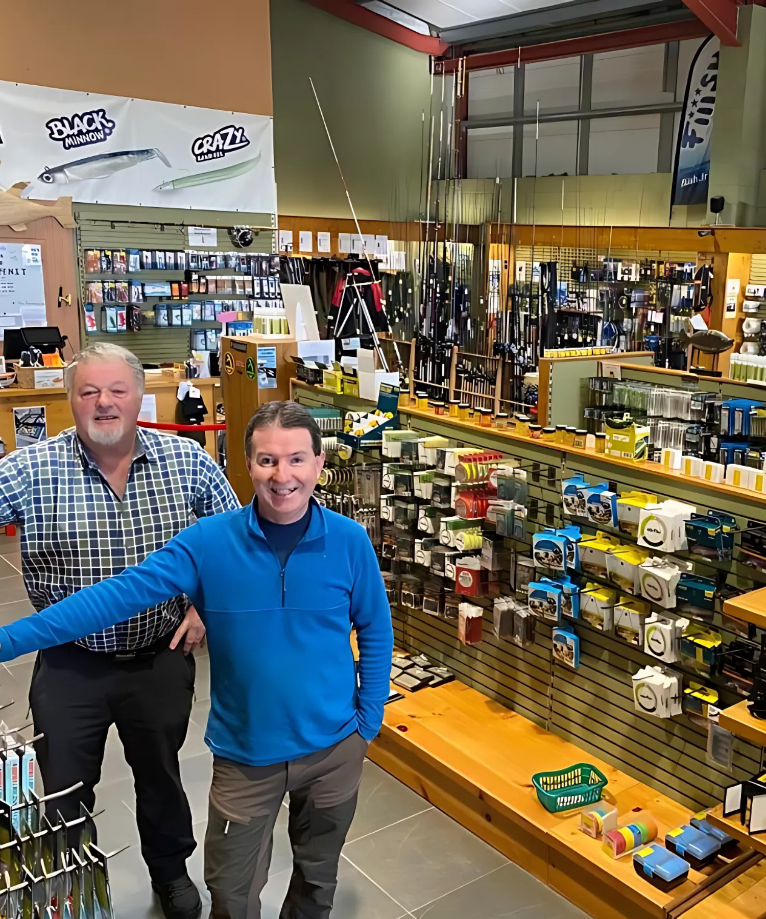 Two men standing in a store with fishing supplies on shelves in Landers Tralee
