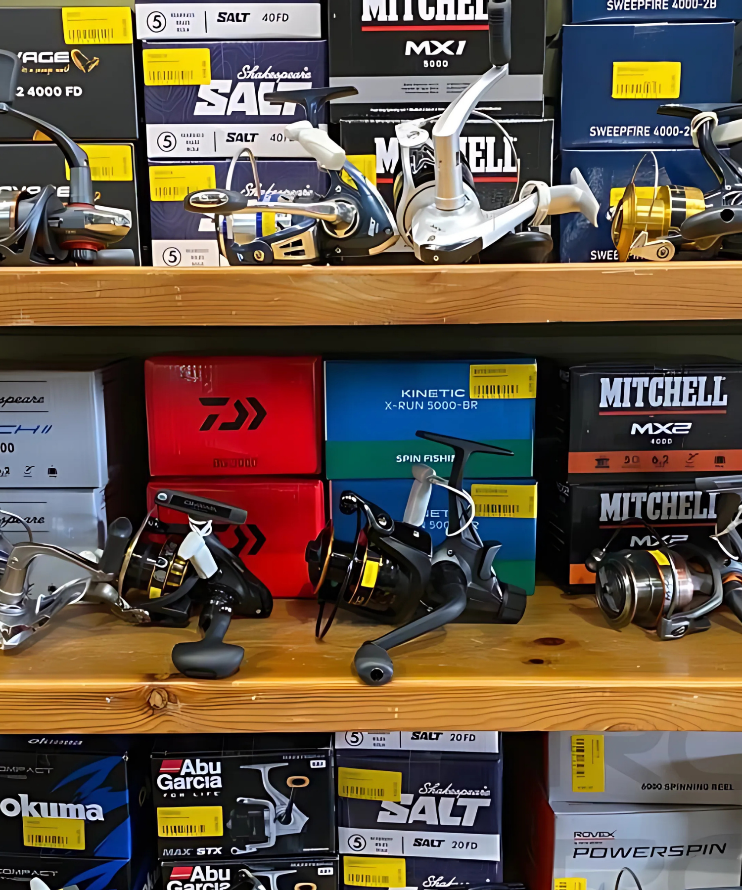 Fishing reels and boxes on a wooden shelf from Daiwa, Mitchell, Shakespeare, Kinetic, Abu Garcia, Savage Gear in Landers Tralee