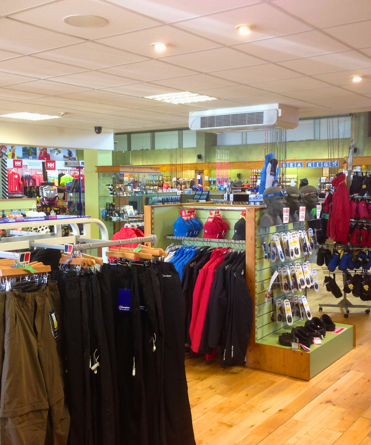 Store interior with clothing racks and displays featuring Helly Hansen, Columbia and more on a wooden floor in Landers Tralee