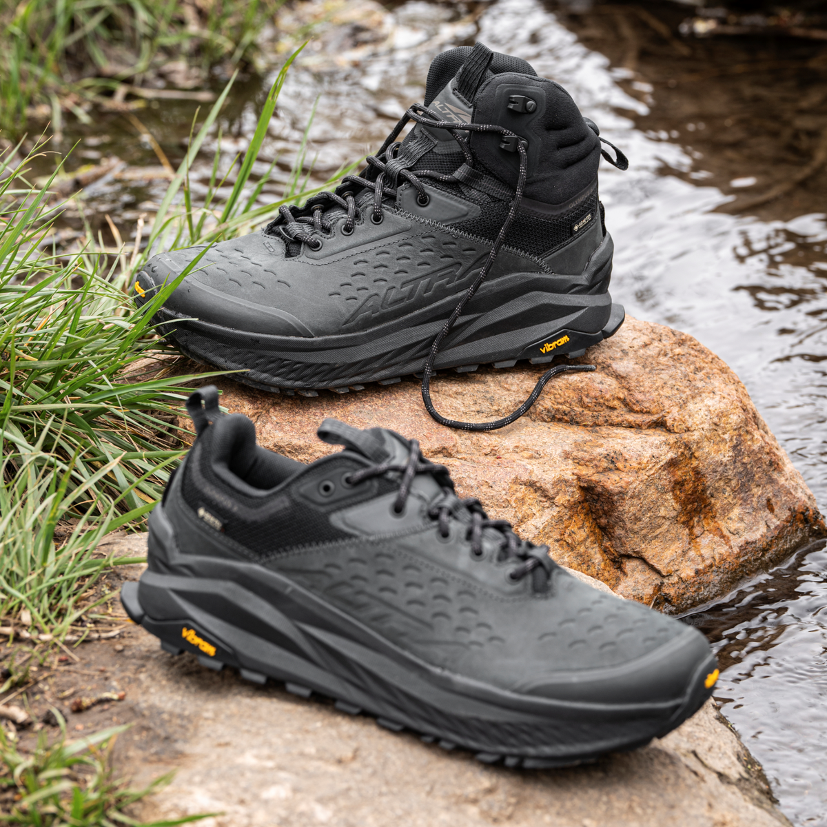 Altra Men's Olympus 6 Hike Low Gore-Tex Trail Shoes Black 000 AL0A85NM sitting on a rock beside a river