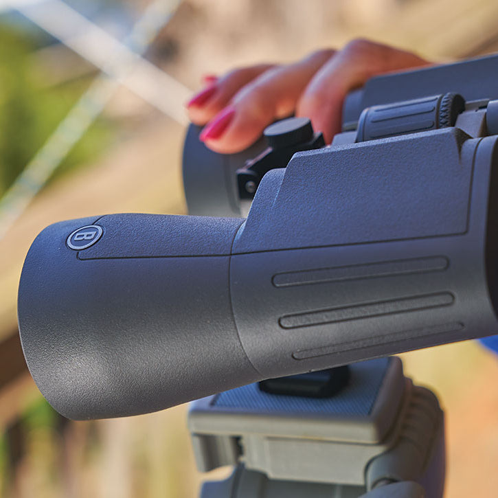 Bushnell Powerview 2 Binoculars on a stand with a woman's hand on it