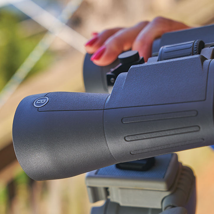 Bushnell 20x50 Powerview 2 Binoculars BHPWV2050 on a tripod with a woman's hand on it