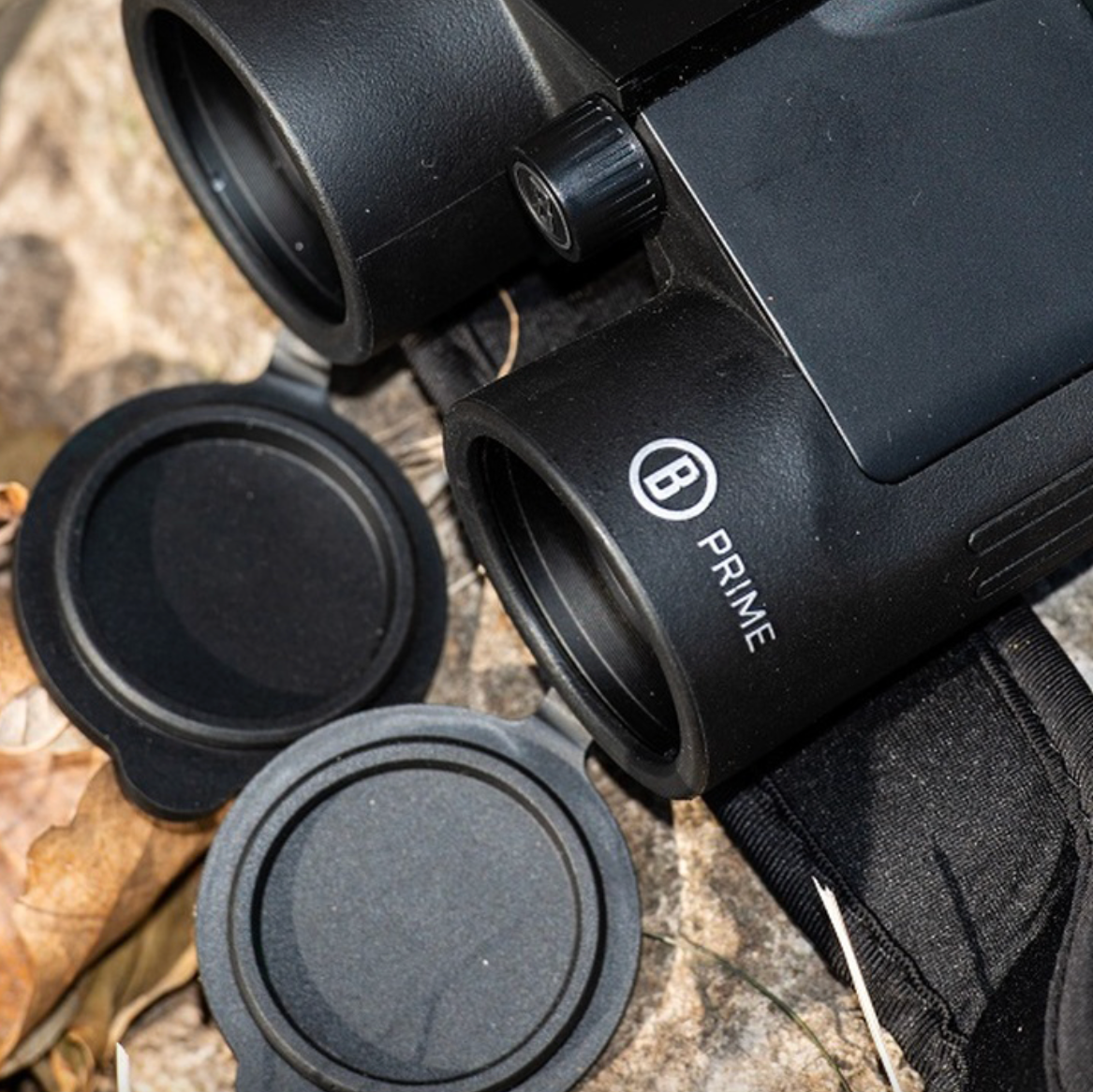 Close up of Bushnell Prime Binoculars sitting on the ground outside