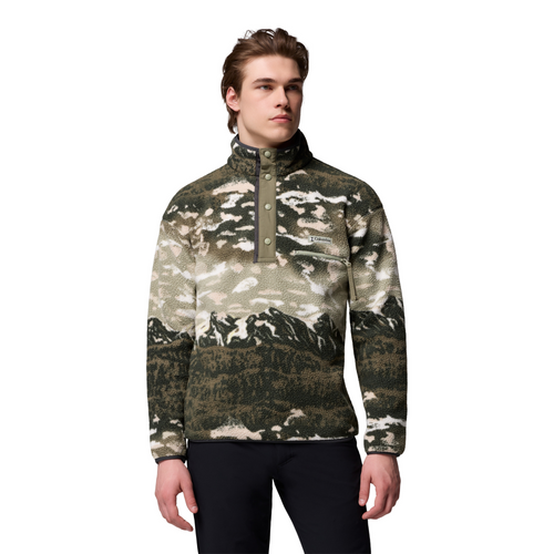 Man wearing a camouflage-patterned pullover with mountain design on a white background