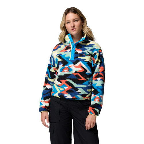 Woman wearing a colorful patterned pullover on a white background