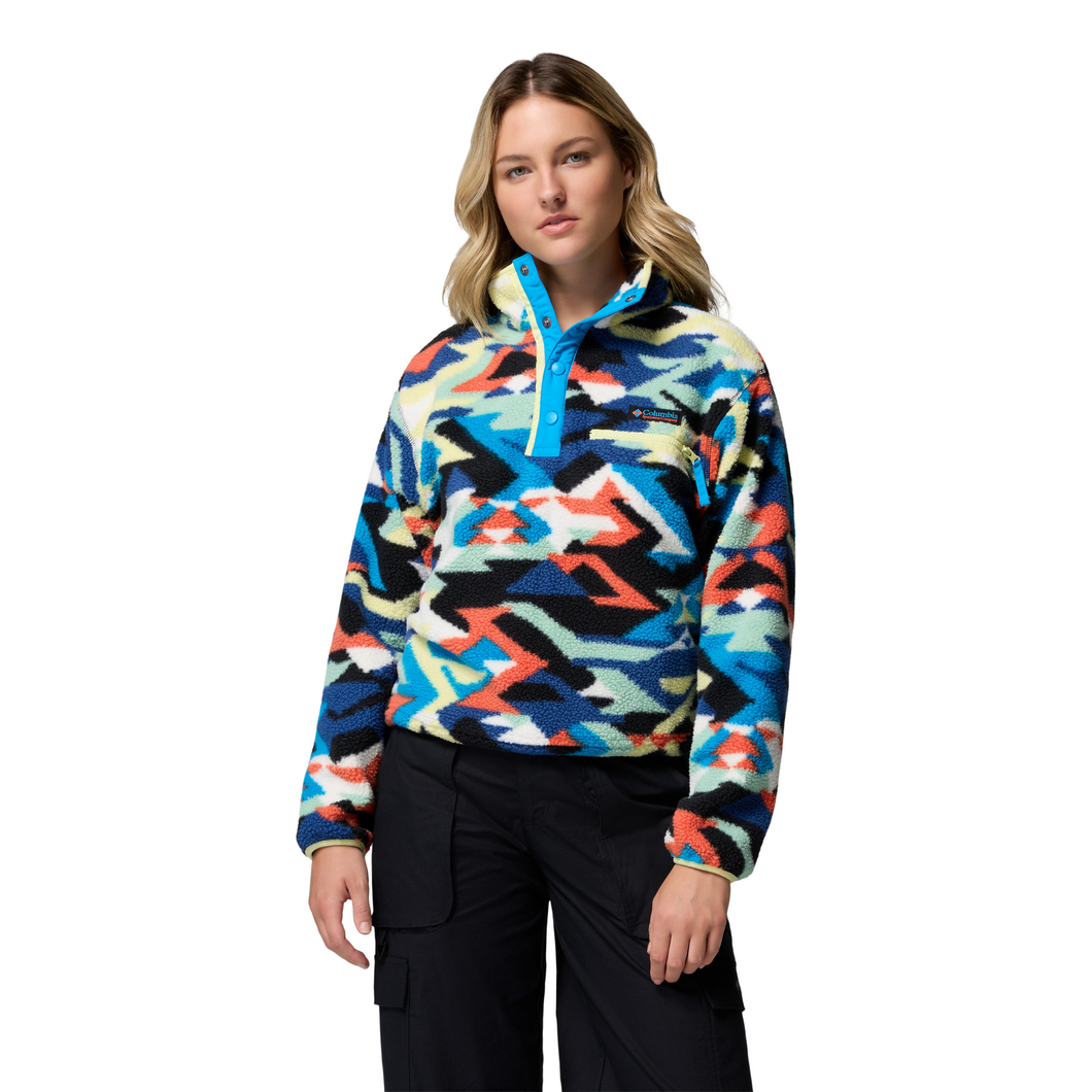 Woman wearing a colorful patterned pullover on a white background
