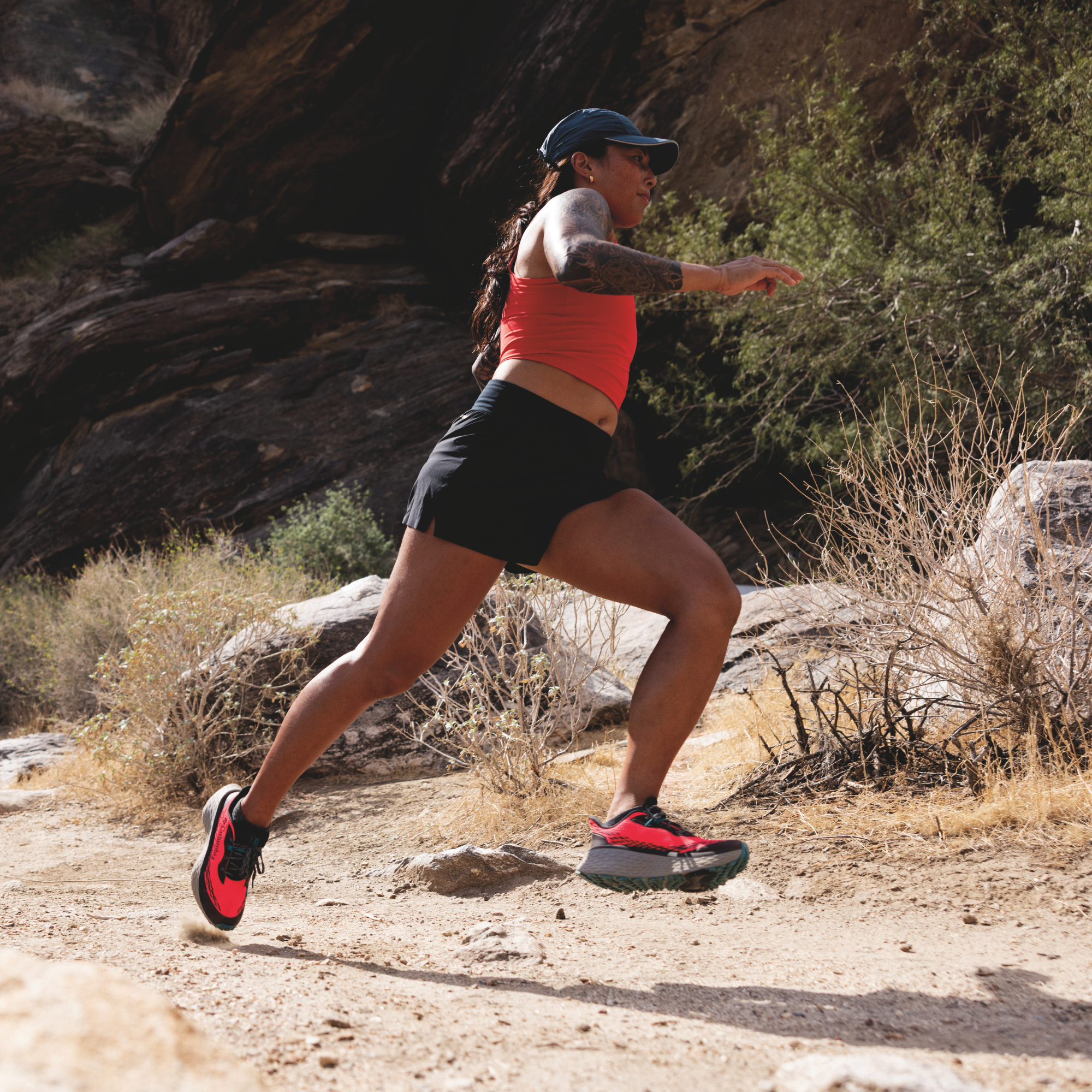 Woman trail running in Columbia Women's Konos Trillium ATR Trail Shoes Neon Sunrise Teal Chloride 648 2145291 on desert gravel surface