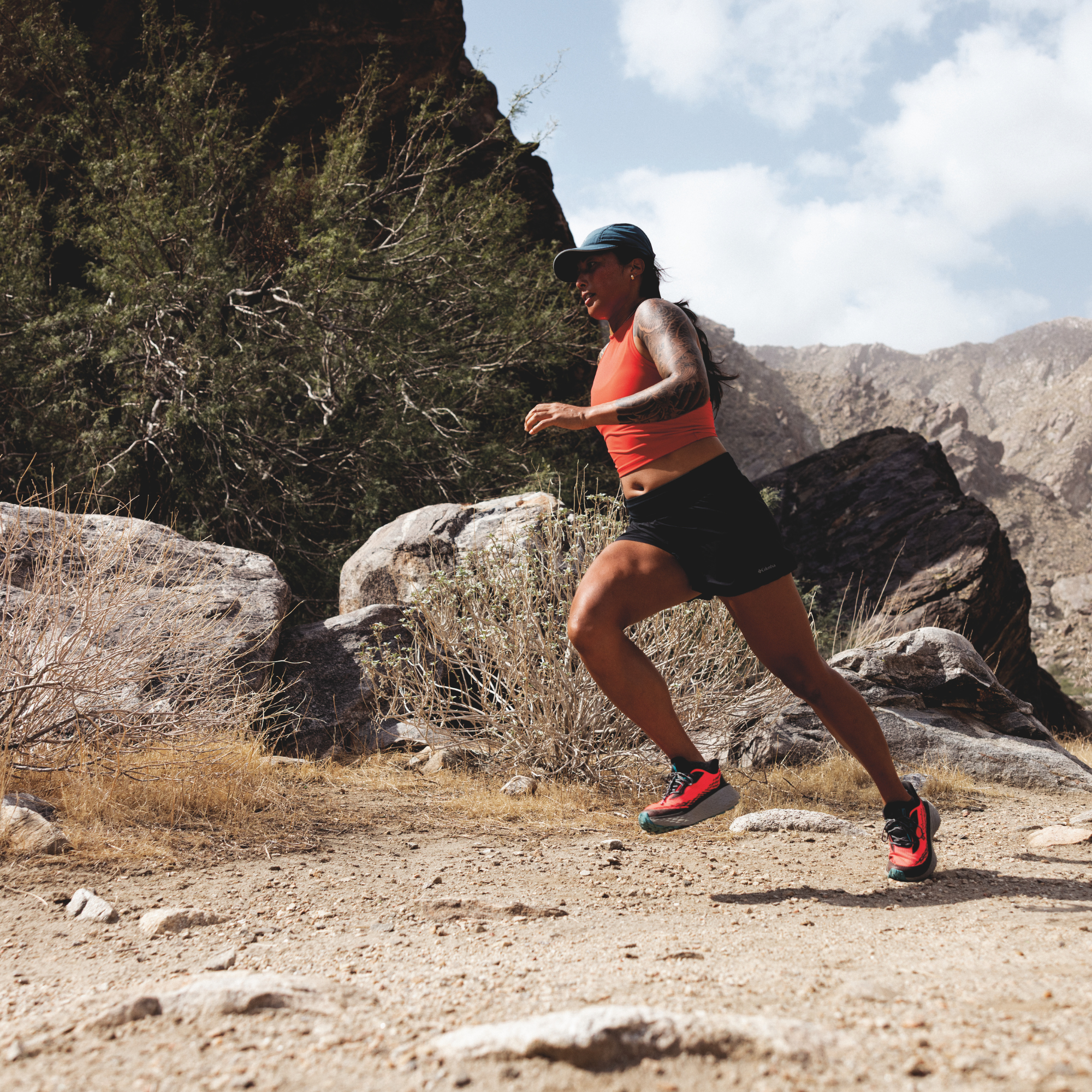 Woman trail running in Columbia Women's Konos Trillium ATR Trail Shoes Neon Sunrise Teal Chloride 648 2145291 on desert gravel surface