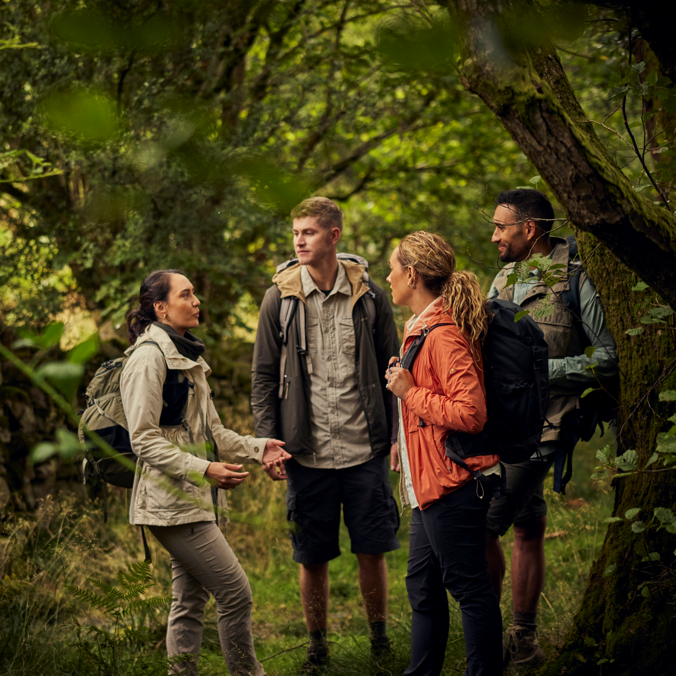 Woman wearing Craghoppers Women's Nosilife Pro III Insect Repellent UPF50 Trousers Soft Mushroom KD7 CWJ1373 in the forest talking to group of people