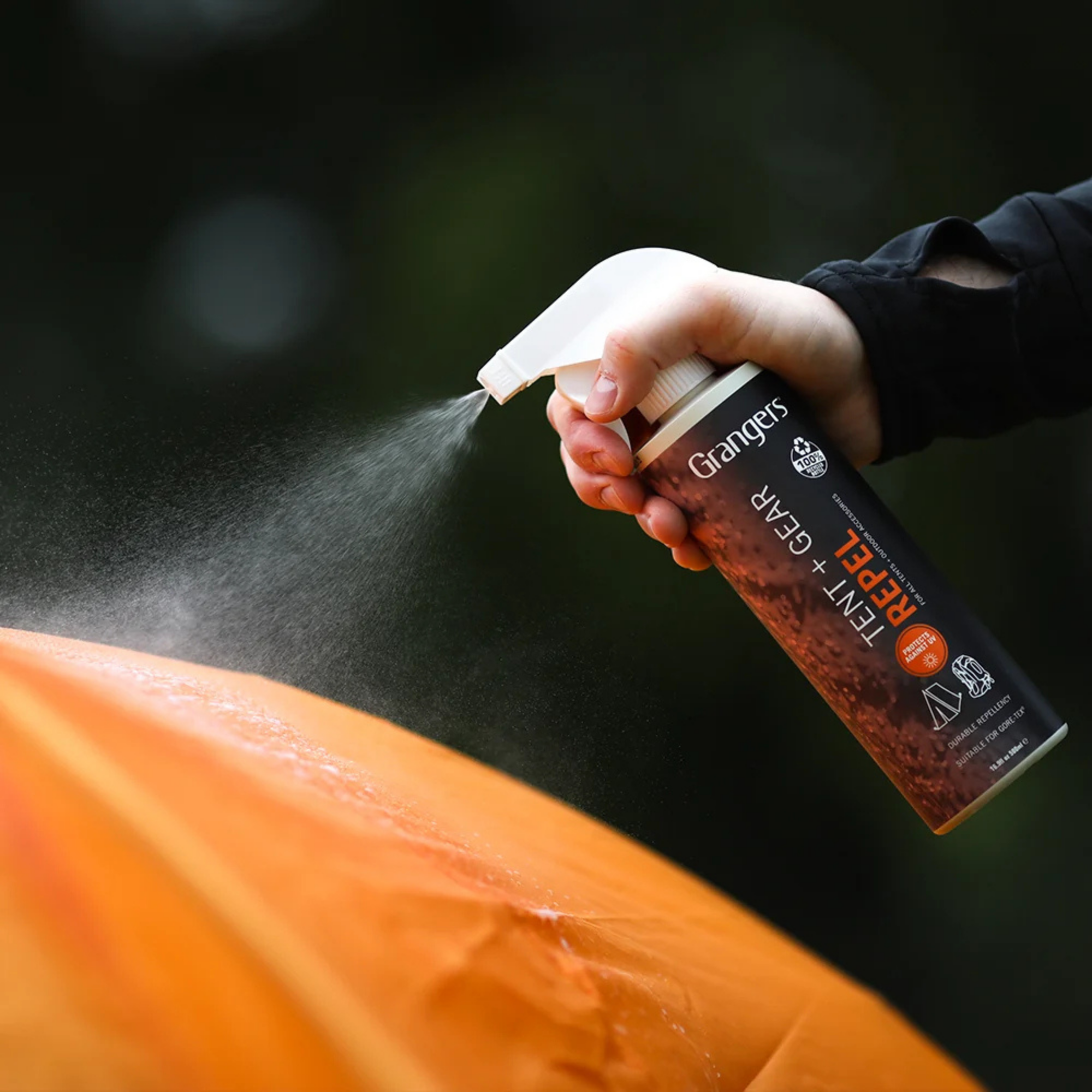 Person spraying a tent with Grangers Tent & Gear Repel 500ml