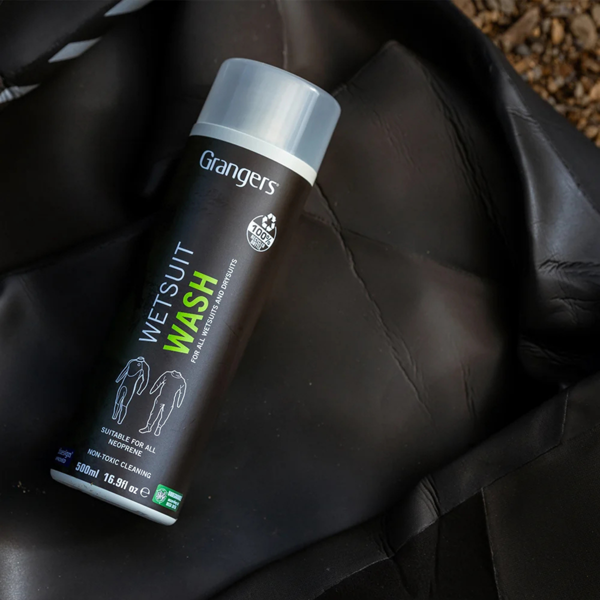 Grangers wetsuit wash bottle on a black wetsuit with a blurred background