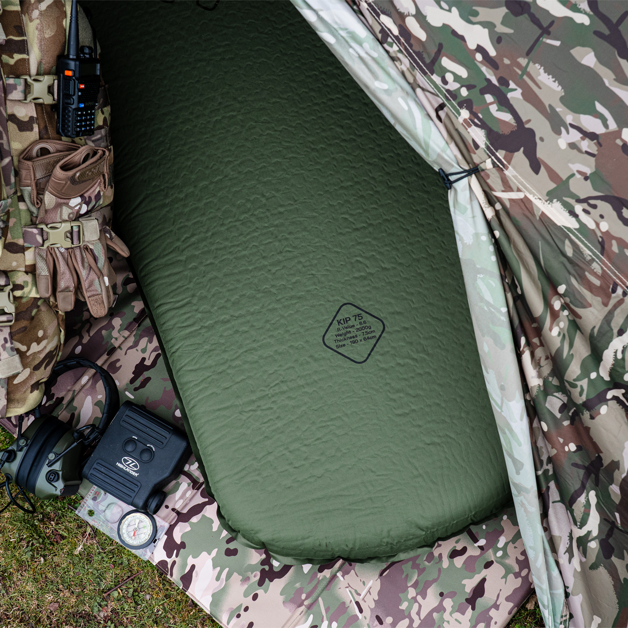 Highlander Self Inflating Kip Sleeping Mat 75mm Olive Green SM132-75 on a camouflage tent floor with camping gear around