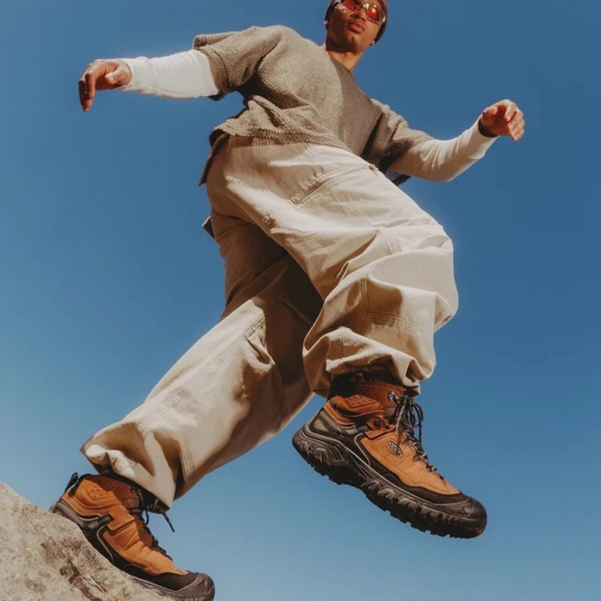 Person hiking in beige clothes wearing Keen Men's Targhee IV Waterproof Mid Trail Boots Wide Fit Bison Black 1029002