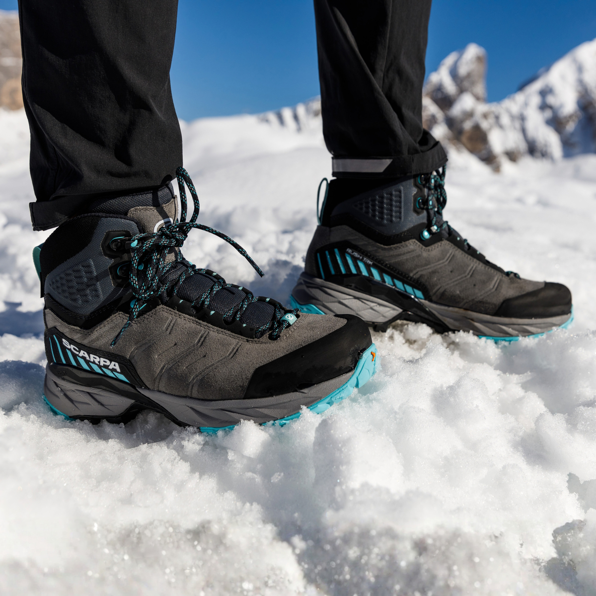 Woman wearing Scarpa Women's Rush TRK Gore-Tex Hillwalking Boots Mid Grey Aqua 63143-202 standing on a snowy mountain