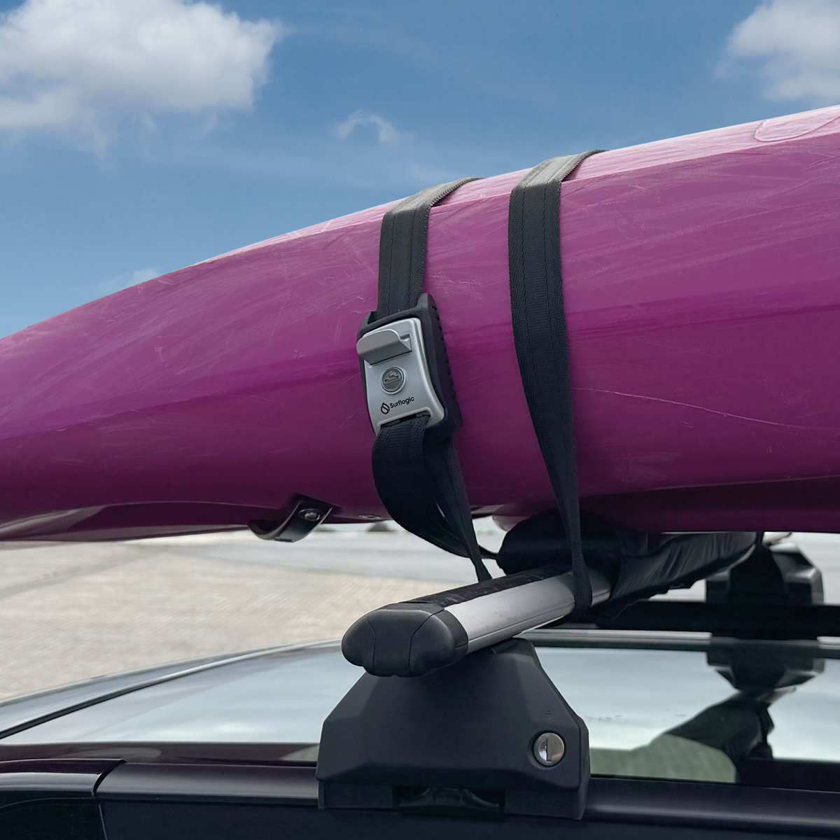 Surflogic Lockable Tie-Down Straps securing a kayak to the roof rack of a car